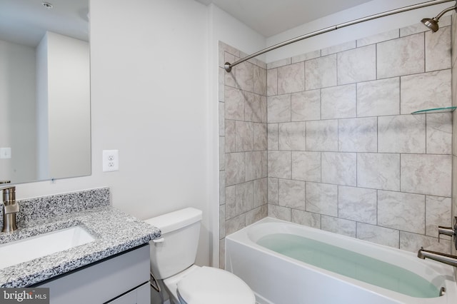 full bathroom featuring vanity, toilet, and tiled shower / bath