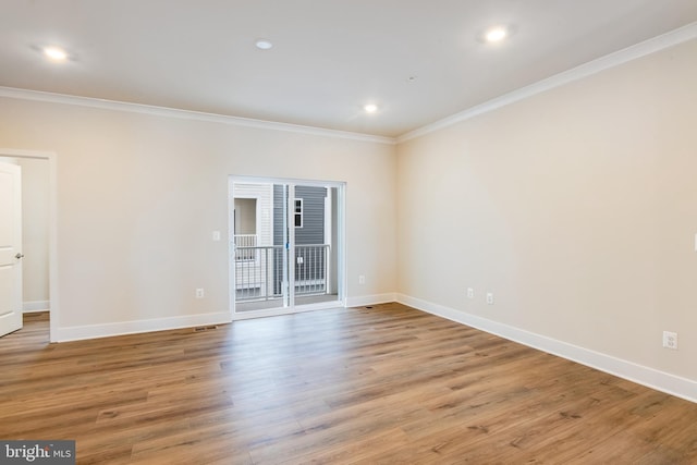 unfurnished room with light wood-type flooring and ornamental molding