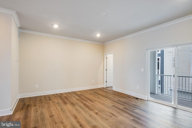 spare room with crown molding and light hardwood / wood-style floors