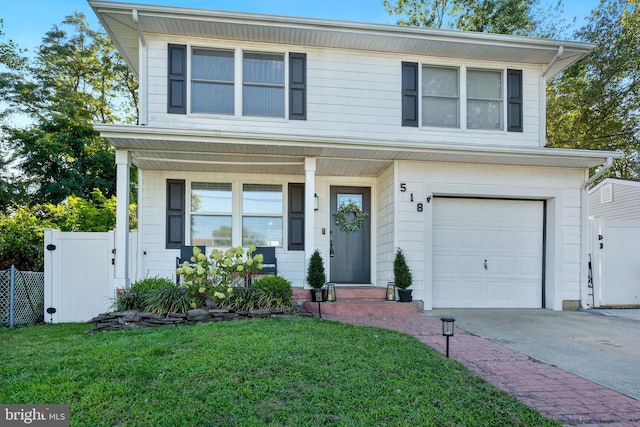 view of front of house with a front yard and a garage