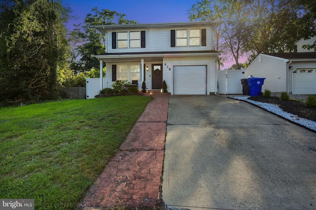 front of property with a garage and a yard