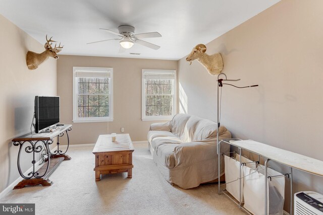 carpeted living room featuring ceiling fan