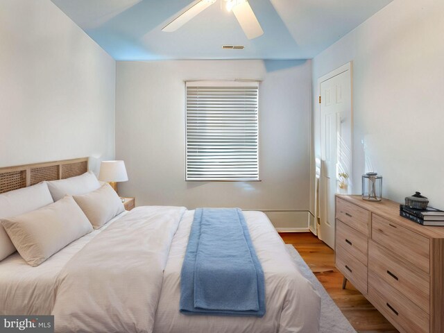 bedroom with light hardwood / wood-style flooring and ceiling fan