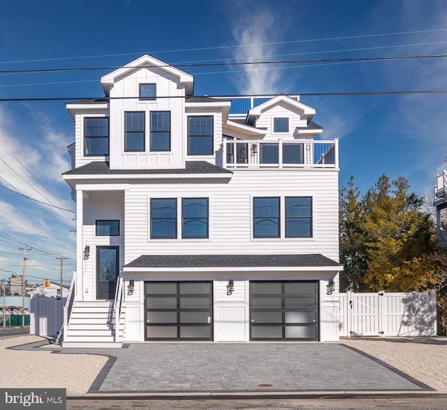 view of front facade with a balcony and a garage