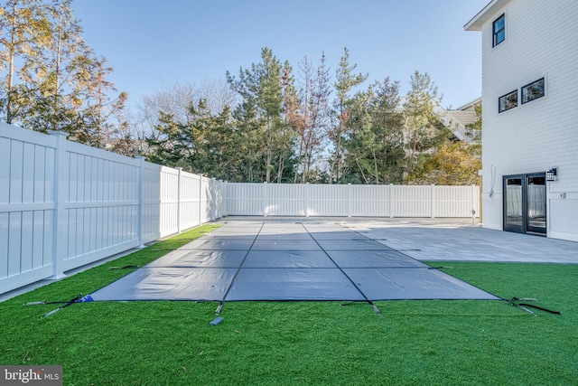 view of pool with a yard and a patio