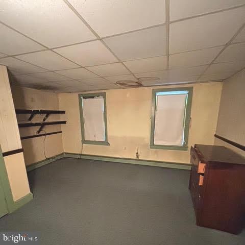 basement featuring a paneled ceiling