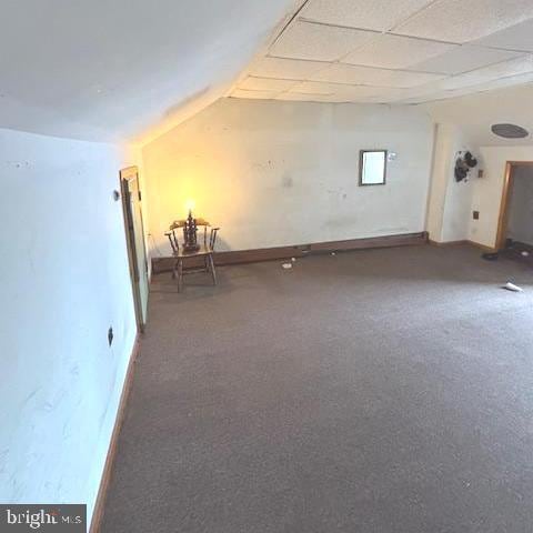 unfurnished room featuring lofted ceiling