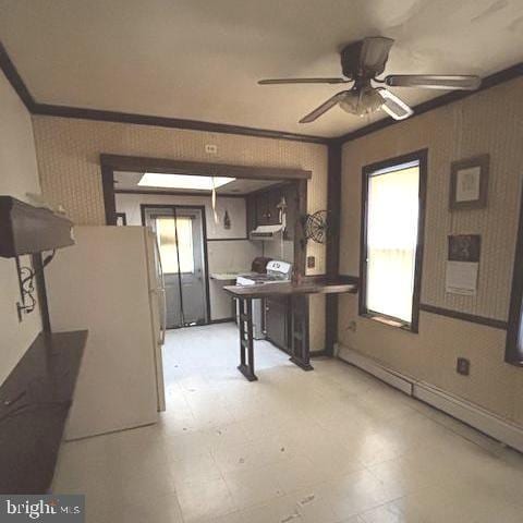 interior space featuring crown molding, a healthy amount of sunlight, and ceiling fan