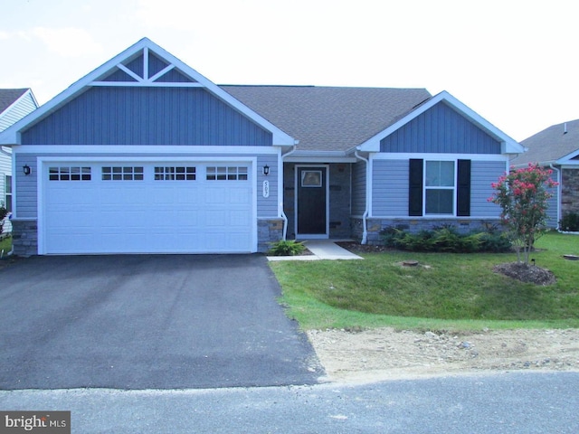 craftsman-style house with a garage and a front lawn