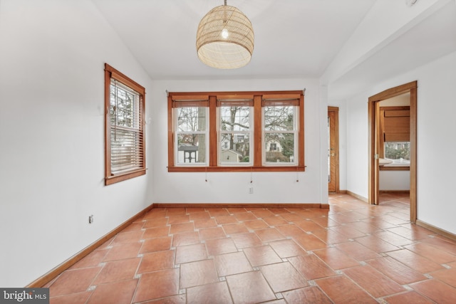 unfurnished room with lofted ceiling