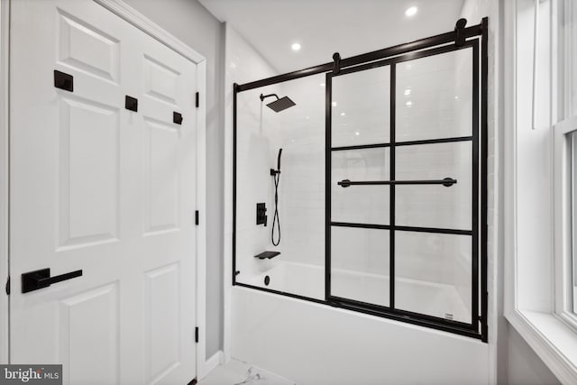 bathroom with shower / bath combination with glass door