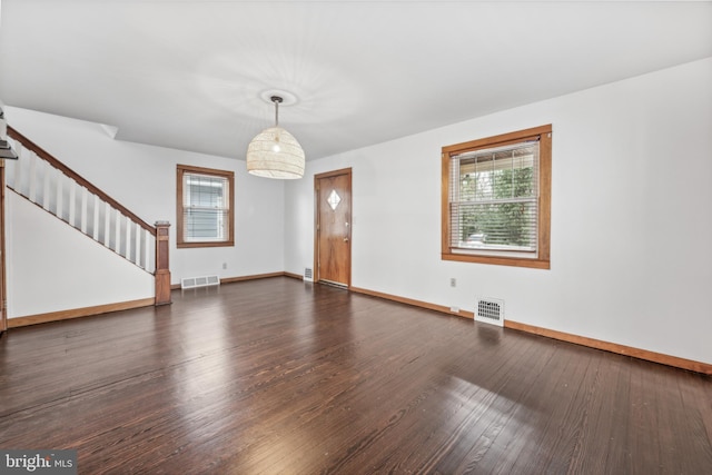 spare room featuring dark hardwood / wood-style flooring