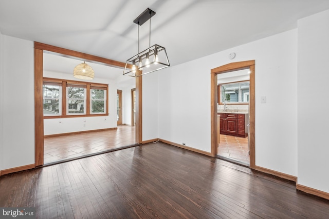 interior space featuring beamed ceiling, sink, and dark wood-type flooring