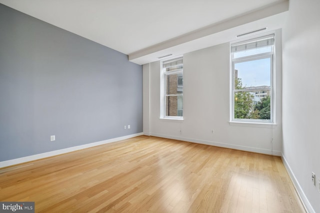 unfurnished room with light hardwood / wood-style flooring