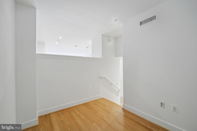 empty room with hardwood / wood-style flooring