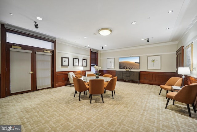 dining space featuring light carpet and crown molding