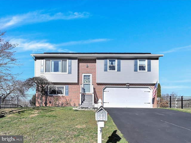 bi-level home featuring a front yard and a garage