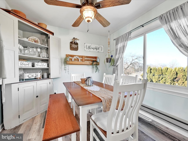 dining space featuring ceiling fan and light hardwood / wood-style floors