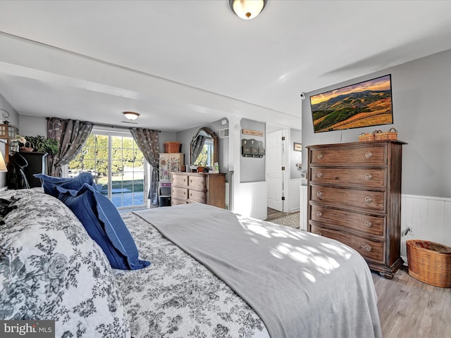 bedroom with light hardwood / wood-style floors and access to exterior