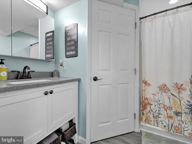 bathroom featuring hardwood / wood-style floors and vanity