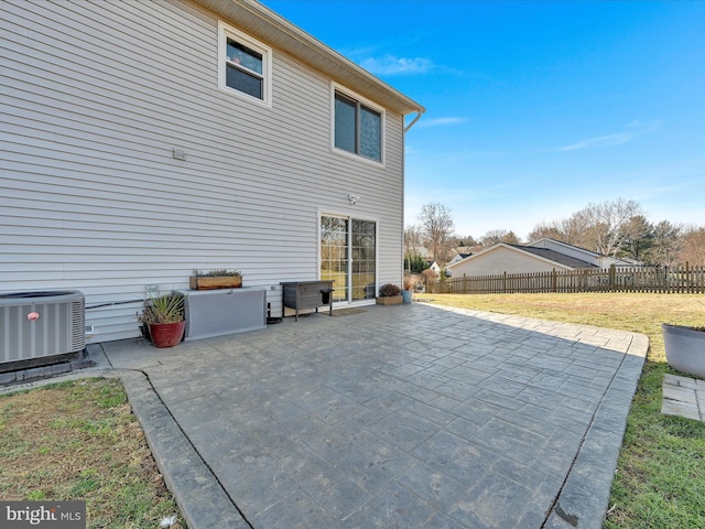 rear view of house with central air condition unit and a patio