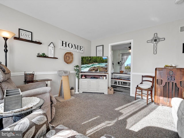 carpeted living room with ceiling fan