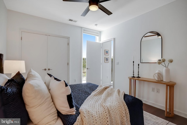 bedroom featuring ceiling fan, dark wood-type flooring, and a closet