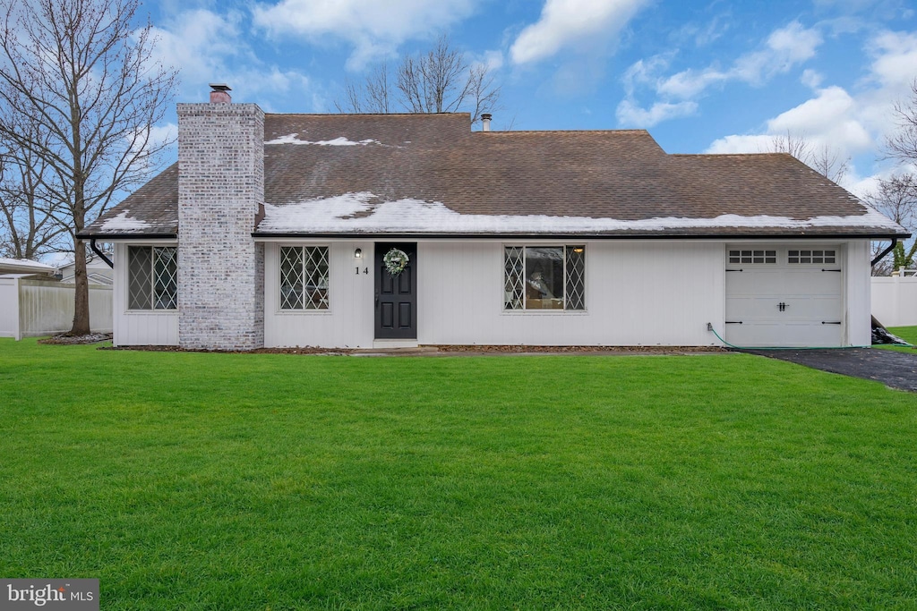 view of front of house with a garage and a front lawn