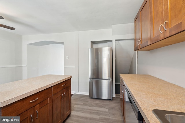 kitchen with ceiling fan, light wood-type flooring, and appliances with stainless steel finishes