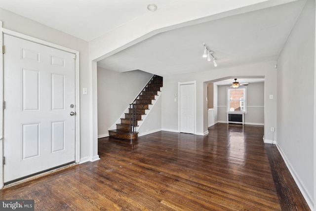 foyer entrance featuring ceiling fan and dark wood-type flooring