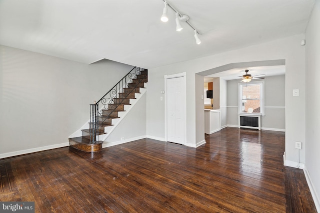 interior space with ceiling fan, radiator heating unit, and dark wood-type flooring