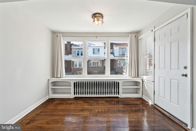 interior space with radiator and dark hardwood / wood-style floors