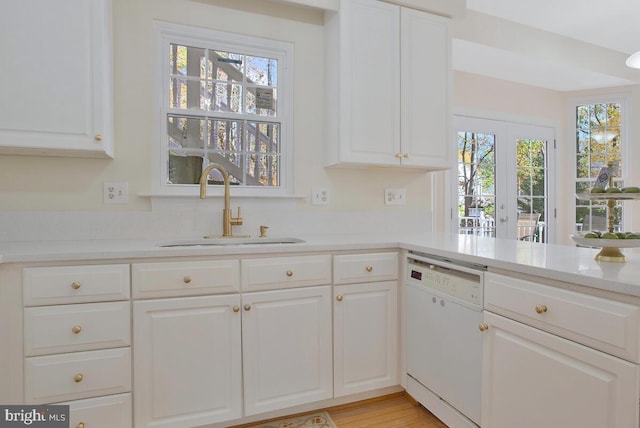 kitchen featuring white cabinets, sink, white dishwasher, and french doors