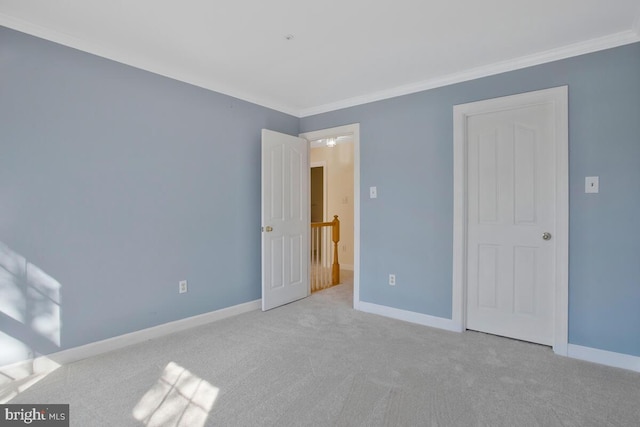 unfurnished bedroom featuring light colored carpet and crown molding