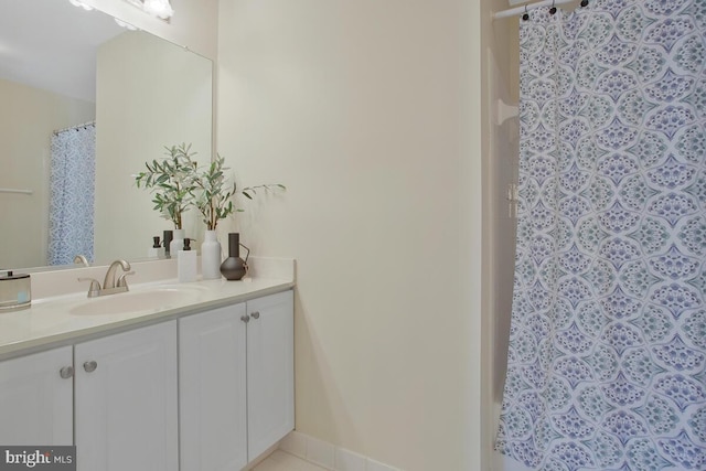 bathroom featuring vanity and curtained shower