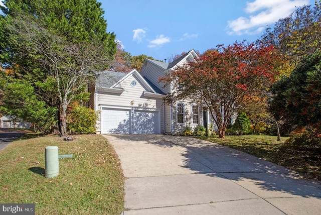 view of front of home with a garage and a front yard