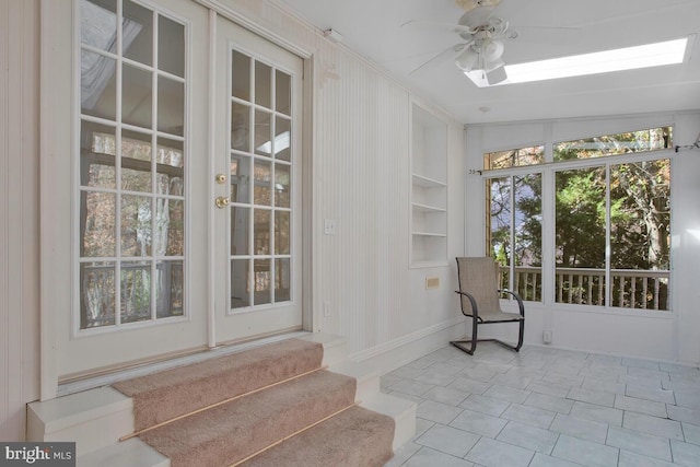 sunroom / solarium with ceiling fan and lofted ceiling