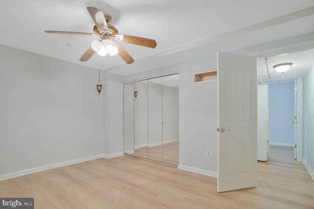 unfurnished bedroom with ceiling fan, a closet, and light hardwood / wood-style flooring