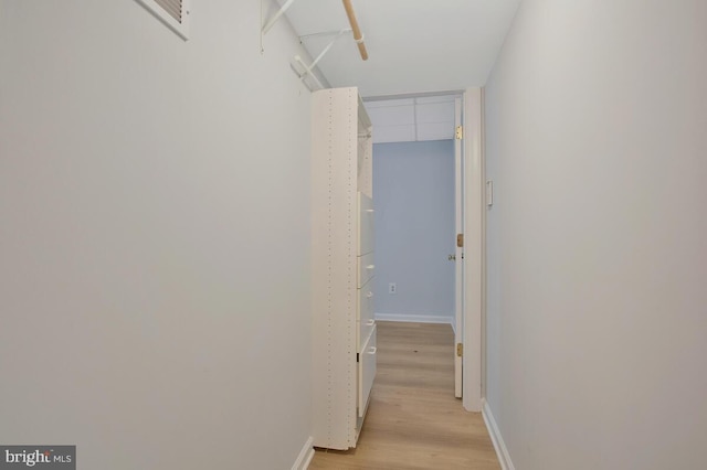 hallway with light hardwood / wood-style flooring