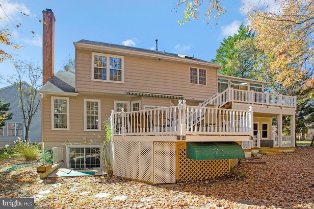 rear view of house featuring a wooden deck