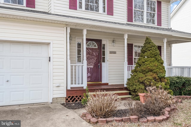 doorway to property with a garage and covered porch