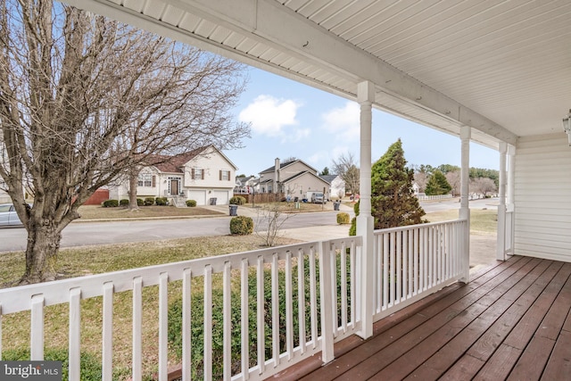 wooden terrace with covered porch and a residential view