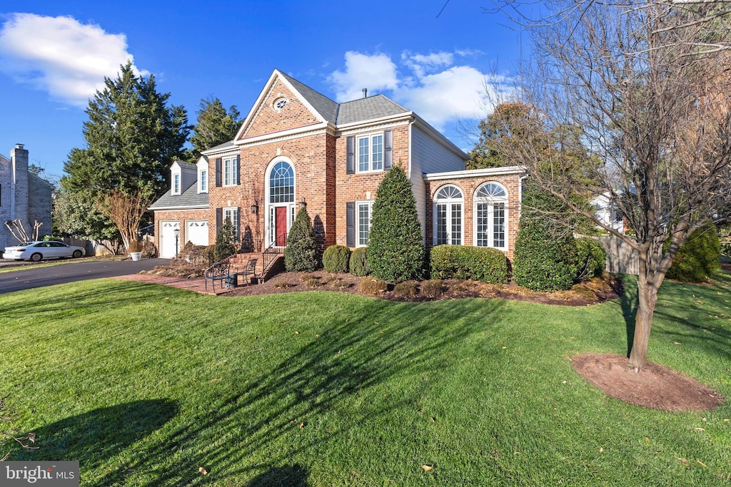 front of property featuring a garage and a front lawn