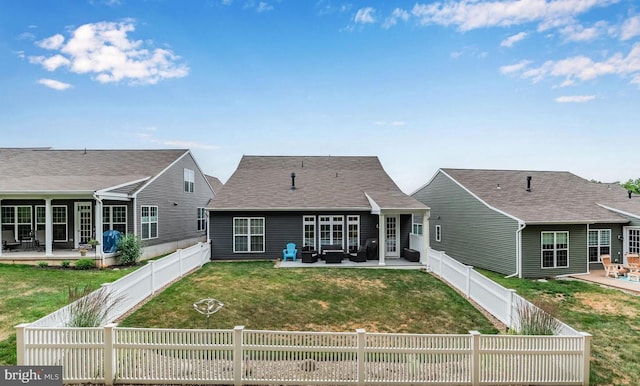 back of property with a patio area, a lawn, and a fenced backyard