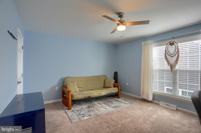 sitting room with carpet floors, a wealth of natural light, and ceiling fan