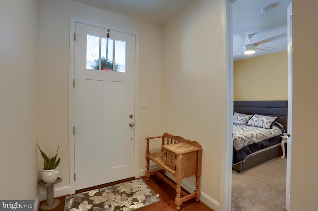 entryway with baseboards, a ceiling fan, and wood finished floors