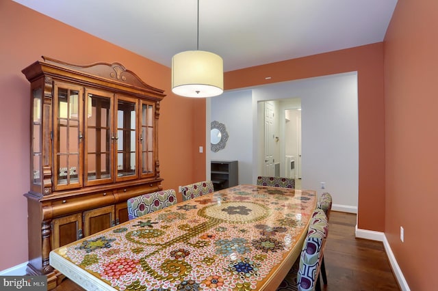 dining area with dark wood-style floors and baseboards