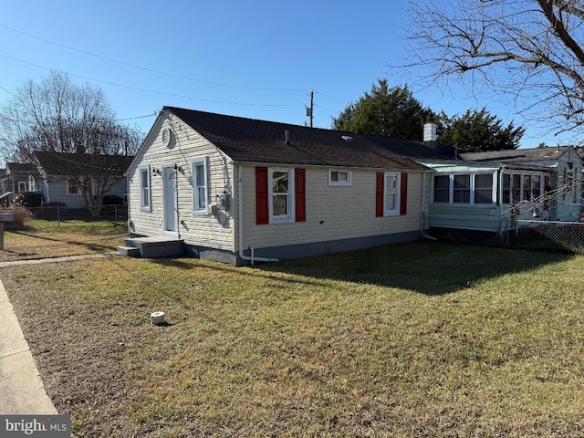 view of side of home featuring a lawn