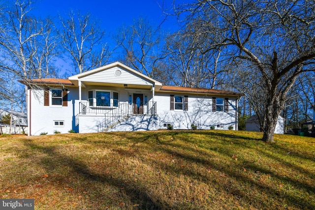 ranch-style house with covered porch and a front yard