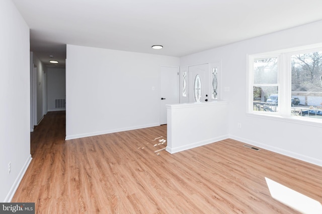 empty room with light hardwood / wood-style flooring